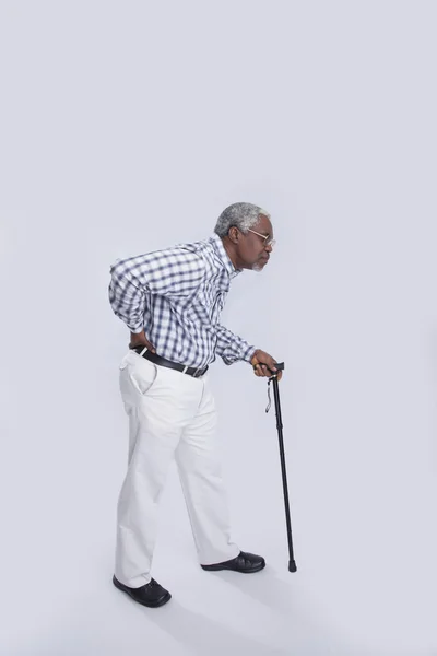 Aged man walks with cane — Stock Photo, Image