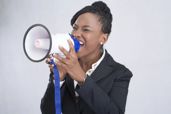 Businesswoman screaming into megaphone — Stock Photo, Image