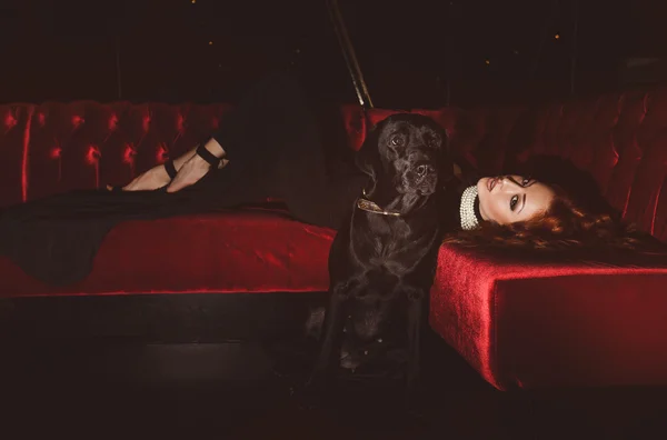 Beautiful woman with black dog — Stock Photo, Image