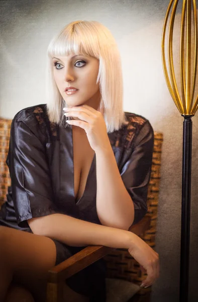 Blonde in a black silk robe — Stock Photo, Image