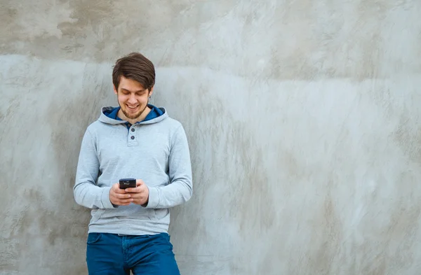 Young man writing sms