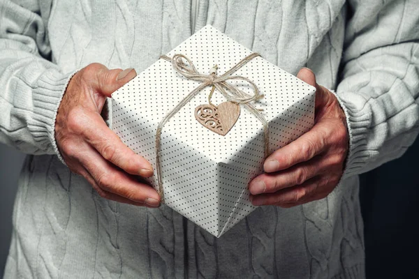 Elderly Senior Holding Christmas Present — Stock Photo, Image