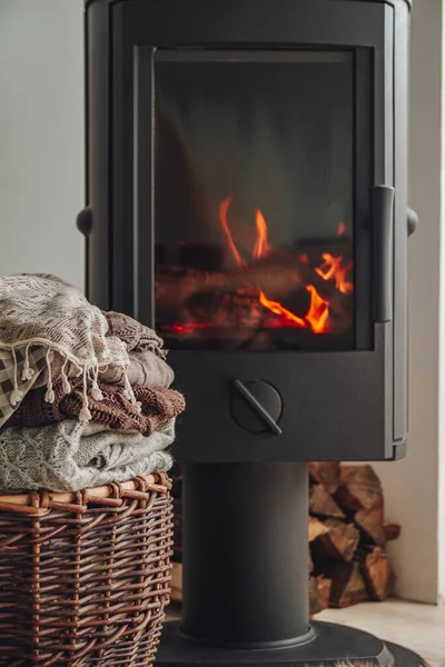 Stack Warm Clothes Wicker Basket Iron Fireplace Glass Door — Stock Photo, Image