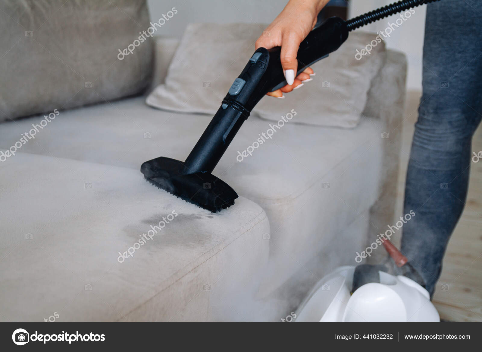 Woman cleaning carpet with a steam cleaner Stock Photo by perfectlab