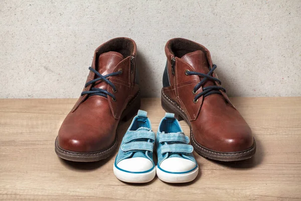 Brutal Brown Men Shoes Cute Baby Gumshoes Wooden Floor — стоковое фото