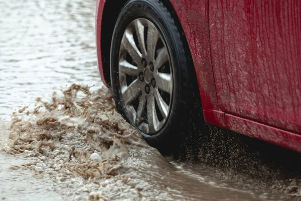 Car stuck in the mud, car wheel in a dirty puddle, rough terrain