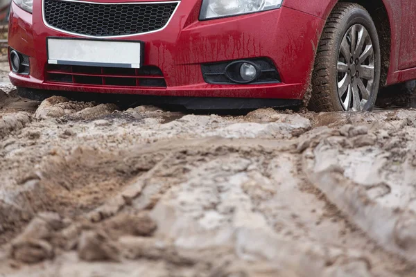 Car stuck in the mud, car wheel in a dirty puddle, rough terrain