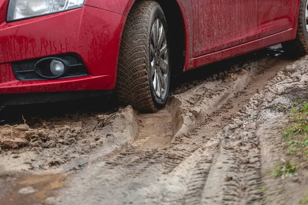 Car stuck in the mud, car wheel in a dirty puddle, rough terrain