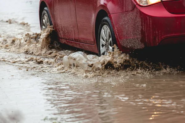 Car stuck in the mud, car wheel in a dirty puddle, rough terrain