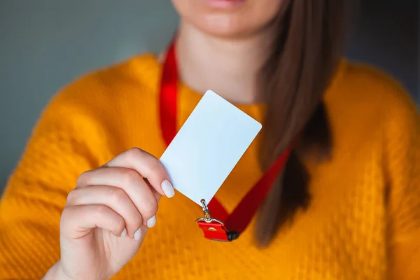 Woman holding badge name tag with blank space mock up