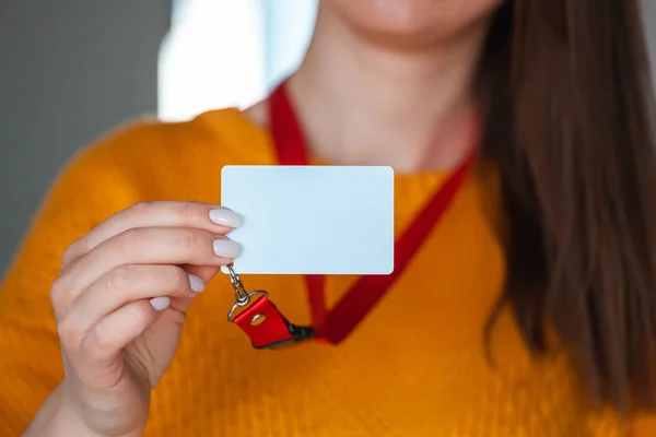 Woman holding badge name tag with blank space mock up