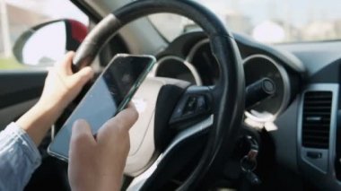 Araba kullanan kadın cep telefonundan mesaj gönderiyor, mesaj yazma ve sürme