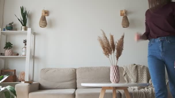 Young Woman Decorates Home Interior Puts Vase Table Sits Sofa — Stock Video
