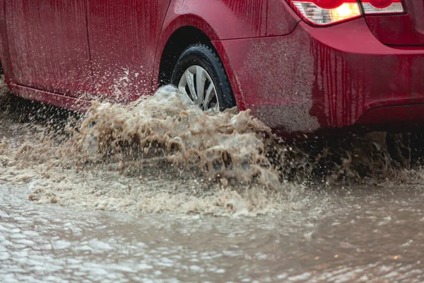 Car stuck in the mud, car wheel in a dirty puddle, rough terrain