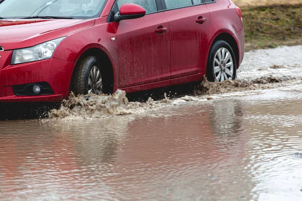 Car stuck in the mud, car wheel in a dirty puddle, rough terrain