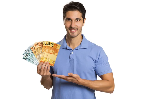 Un hombre de negocios mostrando dinero brasileño —  Fotos de Stock