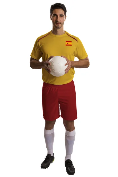 Испанский футболист держит мяч на белом фоне — стоковое фото