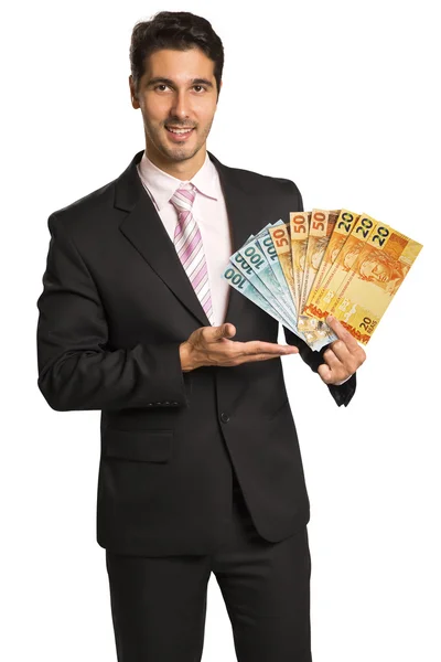 Hombre de negocios sosteniendo dinero brasileño / real — Foto de Stock