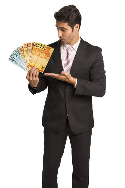 Hombre de negocios sosteniendo dinero brasileño / real —  Fotos de Stock