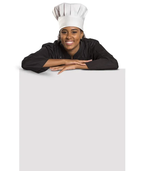 Gelukkige vrouw kok of baker bedrijf over papier teken billboard — Stockfoto