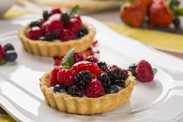 Two Fruit Pies with raspberries, blueberries and mulberries in a — Stock Photo, Image