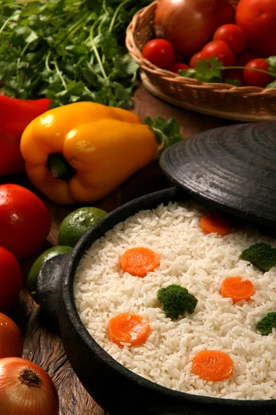 Appetizing healthy rice with vegetables in white plate on a wood — Stock Photo, Image