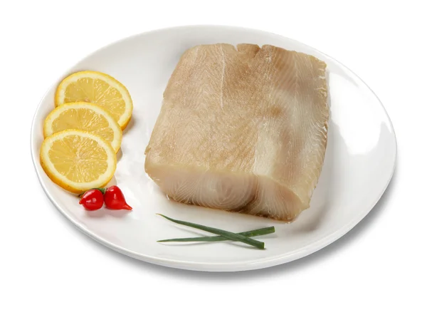 新鲜的鱼鱼片在盘子里分离出的柠檬白色黑色 — 图库照片