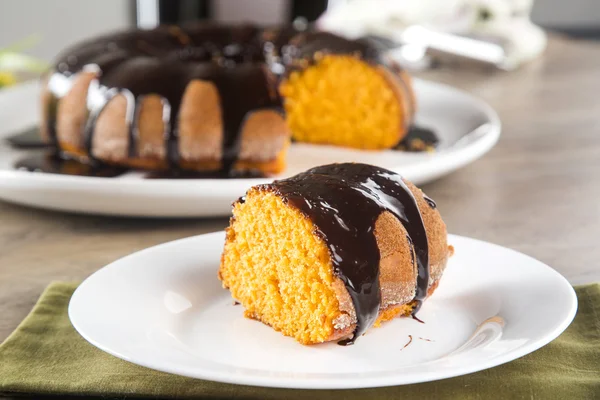 Bolo de cenoura com chocolate e fatia na mesa — Fotografia de Stock