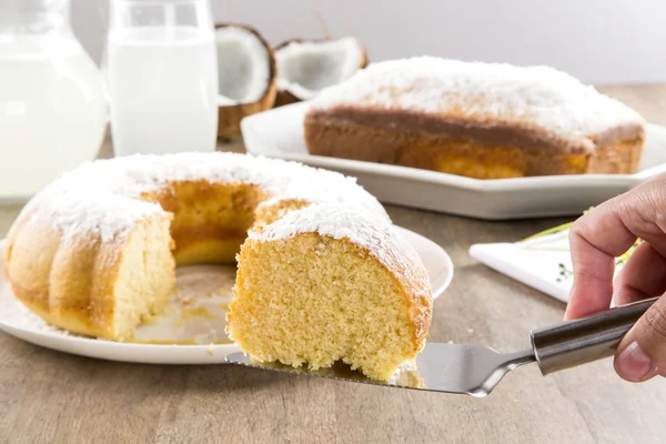 Pastel de coco con rebanada en la mesa — Foto de Stock