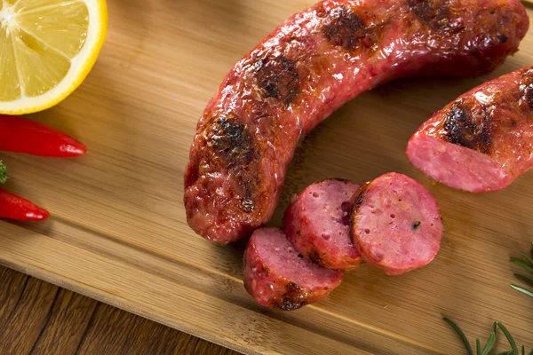 Grilled meat sausages with potatoes and tomatoes — Stock Photo, Image