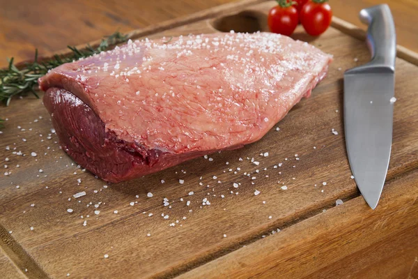 Raw steak on wooden board Royalty Free Stock Photos