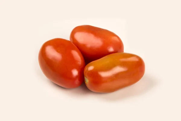 Some tomatoes over a white background — Stock Photo, Image
