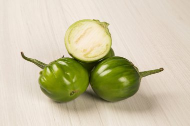 Some green african eggplants over a white background clipart