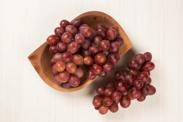 Some red grapes over a white background — Stock Photo, Image