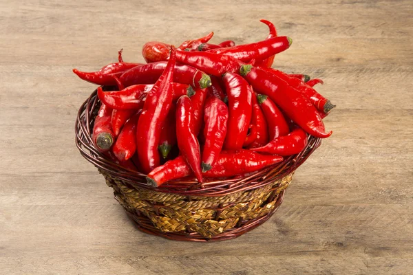 Group of fresh red hot peppers on a wooden table — Stock Photo, Image