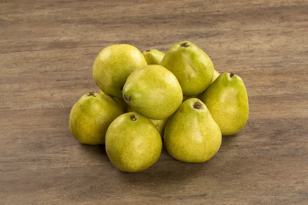 Some pears in a basket over a wooden surface — Stock Photo, Image