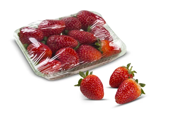 A strawberry cut in a half in front of three entire strawberries — Stock Photo, Image