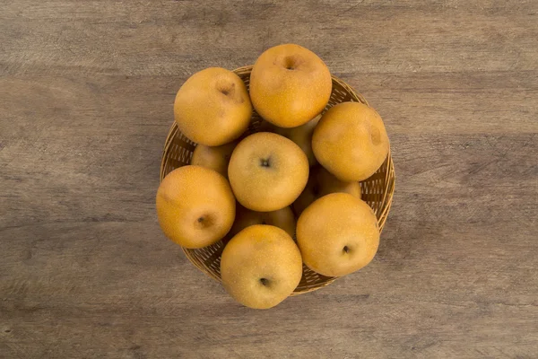Some asian pears over a wooden surface — Stock Photo, Image