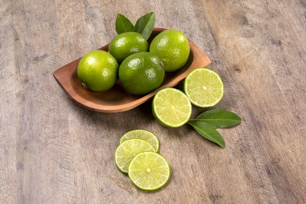 Fresh citrus lime with mint close up on wooden background — Stock Photo, Image