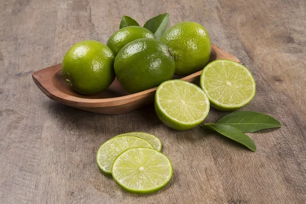 Fresh citrus lime with mint close up on wooden background — Stock Photo, Image