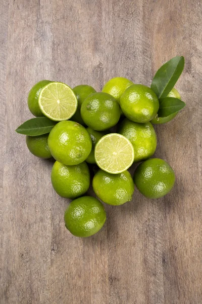 Fresh citrus lime with mint close up on wooden background — Stock Photo, Image