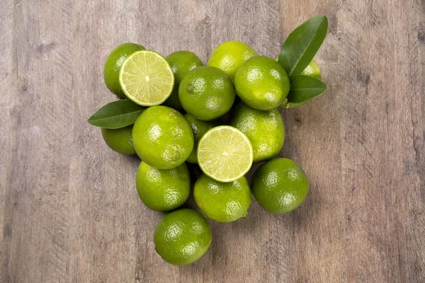 Fresh citrus lime with mint close up on wooden background — Stock Photo, Image