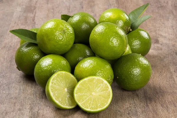 Fresh citrus lime with mint close up on wooden background — Stock Photo, Image