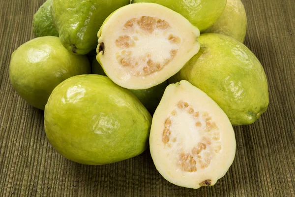 Some brazilian guavas over a striped surface. — Stock Photo, Image