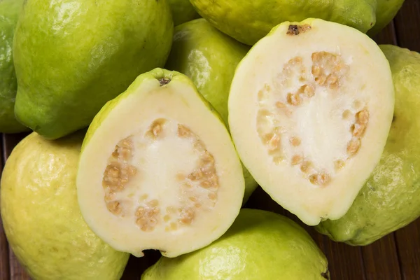 Some brazilian guavas over a striped surface. — Stock Photo, Image