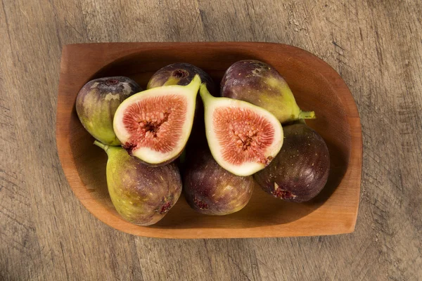 Couple of figs in a pot over a wooden table — Stock Photo, Image