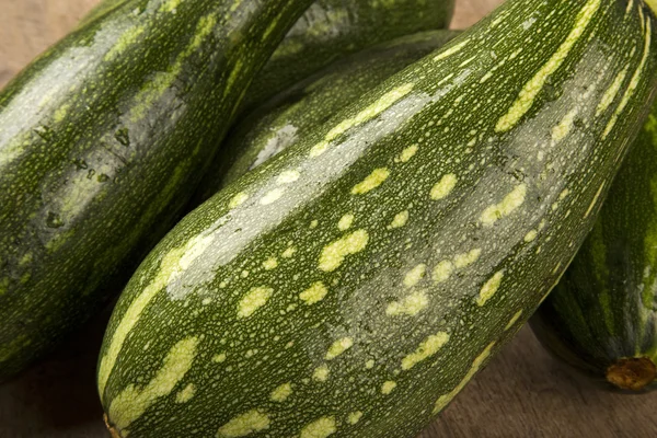 Some zucchinis over a white wooden surface — Stock Photo, Image