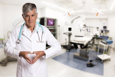 Doctor making a heart with her hands.