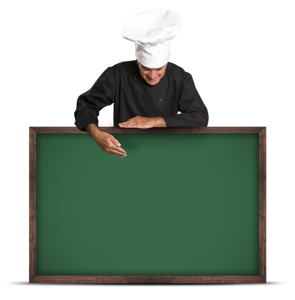 Retrato de um chef profissional segurando um quadro negro . — Fotografia de Stock