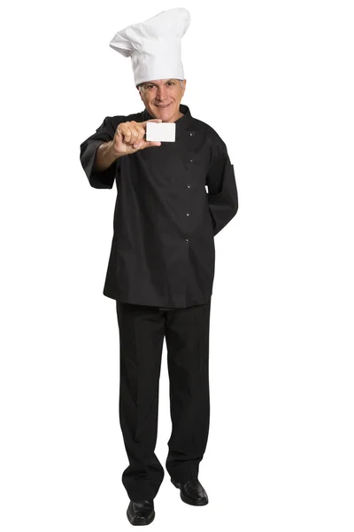 Mature man chef in uniform thumbs up and showing blank visiting card. — Stock Photo, Image